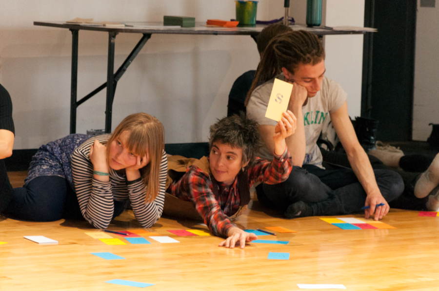 Photo de trois personnes participantes à l'Embodied Talkl deux sont allongées sur le plancher et l'autre est assise.